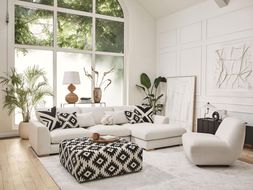 DFS Calix right hand facing large chaise end sofa in in ivory boucle, Calix pattern large square footstool, and Calix ripple accent chair in ivory boucle